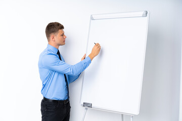 Young businessman giving a presentation on white board giving a presentation on white board and...
