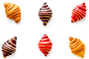Set of croissants - chocolate, berry, classic - on white background top view