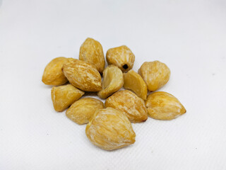 candlenut with a white background. hazelnut is one of the herbs and spices.