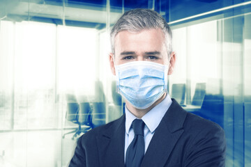 Businessman in suit wearing a face mask