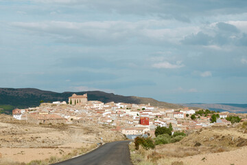 Fototapeta na wymiar Asphalt country road leading to Alacon village, deserted land of Teruel, Aragon, Spain.