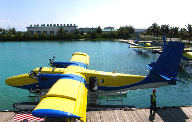 Sea plane to tropical Maldives romantic atoll islands paradise luxury resort about coral reef. Honeymoon