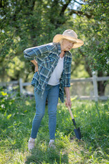 Elderly woman having a backache while gardening