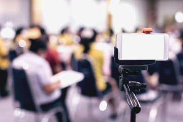 Mockup image blank screen of Modern smart phone. Mobile phone recording video in meeting room.