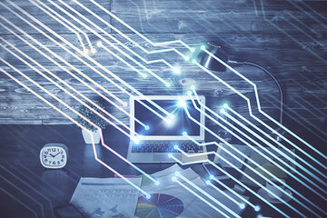 Double exposure of laptop computer and technology theme hologram. Concept of freelance work.