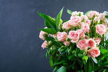 Bouquet of several branches of pink roses. Background of pink roses
