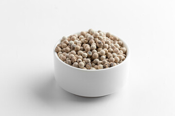 Isolated white peppers spice in a white bowl