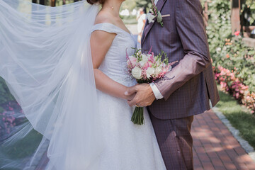 bride and groom in the park together at wedding