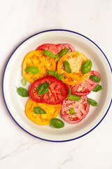 salad of tomatoes and basil on a plate
