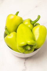 green fresh peppers in a white cup
