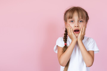 Cute Little Girl Covering Her Mouth Showing Intense Expression of Fear and Terror, Isolated