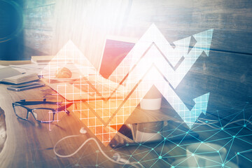 Computer on desktop with point up arrows hologram. Double exposure. Concept of success.