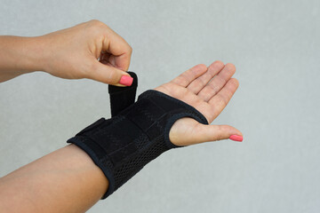 Wrist brace with adjustable straps and slip-on design.
