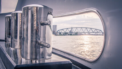 View of a bridge over water through a hole of a yacht 