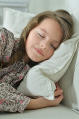 Portrait of cute girl sleeping on sofa