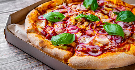 Pizza with chicken and barbeque sauce . Italian pizza on wooden table background
