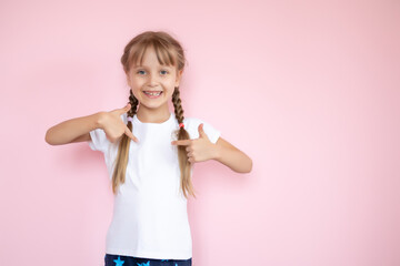 t-shirt design concept - smiling little girl in blank white t-shirt pointing at herself
