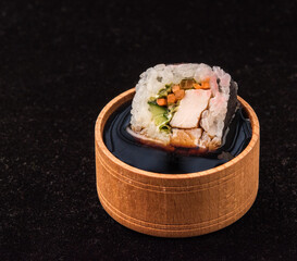 Roll sushi in soy sauce. Japanese national cuisine concept.