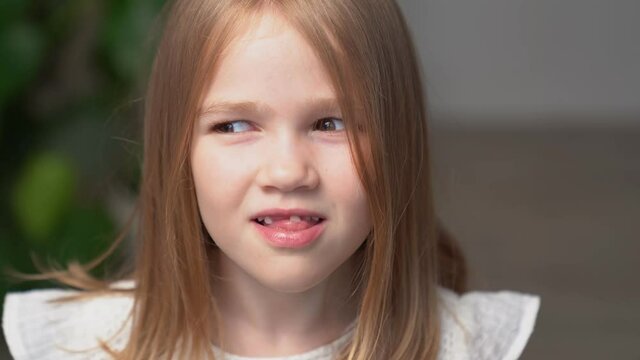 little girl sways front milk tooth tongue and fingers.