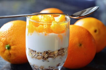 Cereal bowl with yoghurt and fresh cut orange pieces
