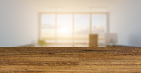 blurred interior on a wooden table background.Head office with a large window. modern furniture.. 3D rendering. Sunset
