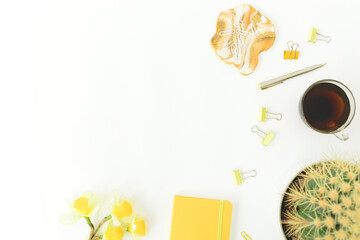 Resin art with yellow diary, cup of tea, clips and flowers on white background. Flat lay