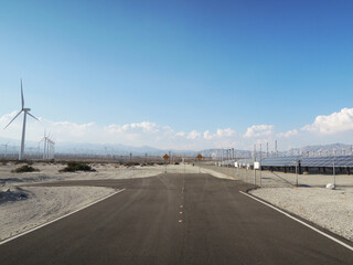 Naklejka premium End of the road with a view of wind turbines in the wilderness