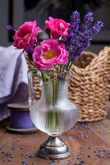 Small vintage glass vase with wild pink roses and purple lavender