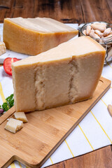 Big wedges of parmigiano-reggiano parmesan hard Italian cheese made from cow milk or Grana Padano