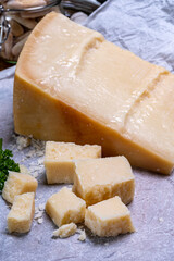 Big wedge of parmigiano-reggiano parmesan hard Italian cheese made from cow milk or Grana Padano