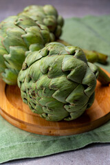 Fototapeta premium Big ripe uncooked green globe artichoks vegetables