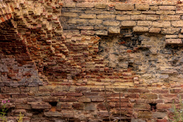 Background of old vintage dirty brick wall with peeling plaster, texture