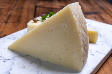 Pieces of matured pecorino romano italian cheese made from sheep milk in Lazio, Sardinia or Tuscany