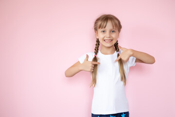 t-shirt design concept - smiling little girl in blank white t-shirt pointing at herself