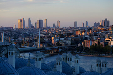 Fototapeta premium The Halic Metro bridge, left, and the skyline of the european side of Istanbul, Turkey, are seen in a photo taken from Suleymaniye mosque during a summer afternoon.