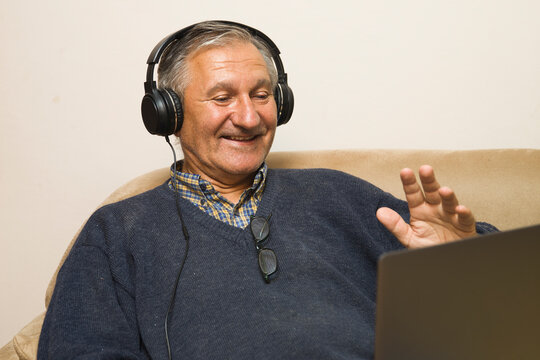 Modern Elderly Man Siting At Home And Having Online Video Call