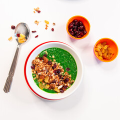 fresh greens and granola smoothie on white table. Healthy vegan food.