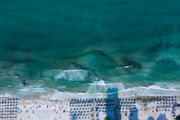 Thassos seaside beach with turquoise water and big waves aerial view.