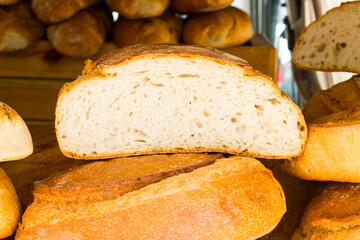 Sourdough,whole wheat breads stack and one sliced