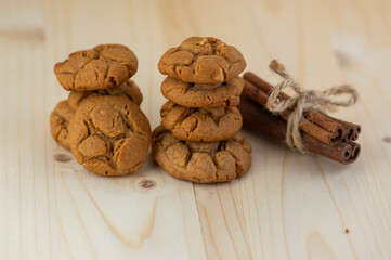 Very tasty peanut butter biscuits on bamboo light brown wooden board, golden baked healthy