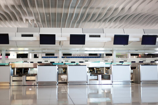 Check-in counter with monitors in interior hall of airport