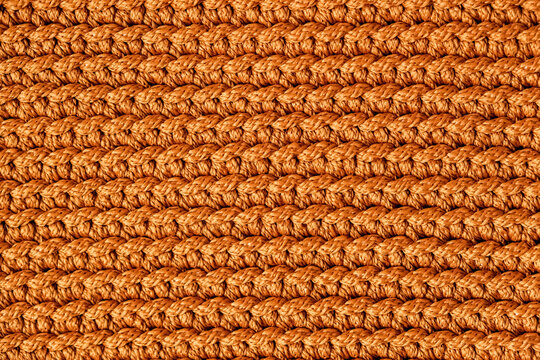 Orange knitted fabric texture background. Top view. Copy, empty space for text