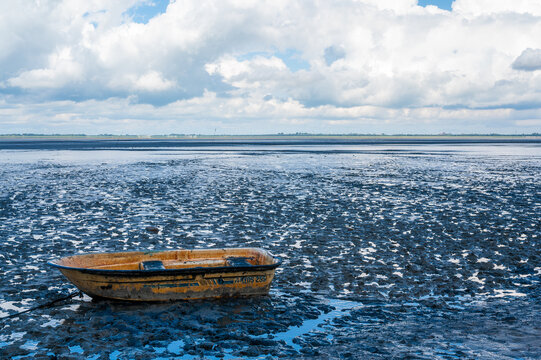 a single boat in the wadden sea at ebbe
