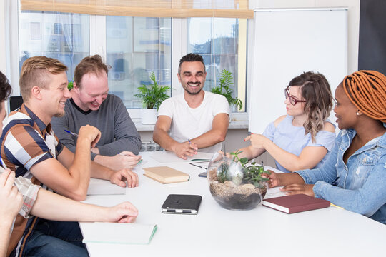Group of happy multiracial people in a meeting room studying or working together. Advanced training, education in the company
