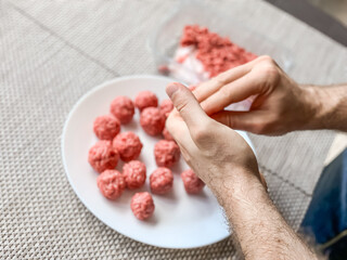 Man hands preparing meatballs with raw mincemeat