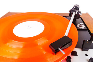 Vintage turntable with a red vinyl isolated on white