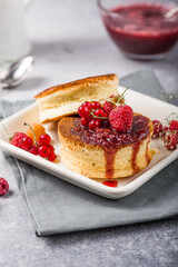 Close up Fluffy Soufflé Japanese pancake recipe with berry. Trendy asian food for breakfast.