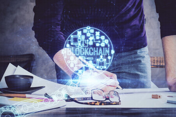 Man's hands working with notes background. Cryptocurrency and finance concept.