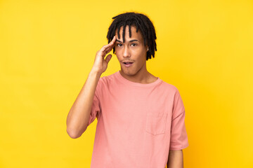 Young african american man isolated on yellow background has just realized something and has...