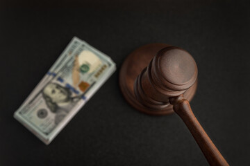 Wooden Judges gavel and bundles of dollars. Corrupt court. Bribery in legislation